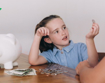 Young girl with a piggy bank and coins
