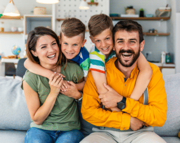 Parents and children sitting together on couch