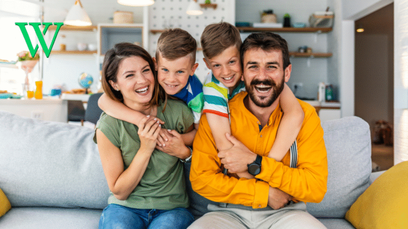Parents and children sitting together on couch