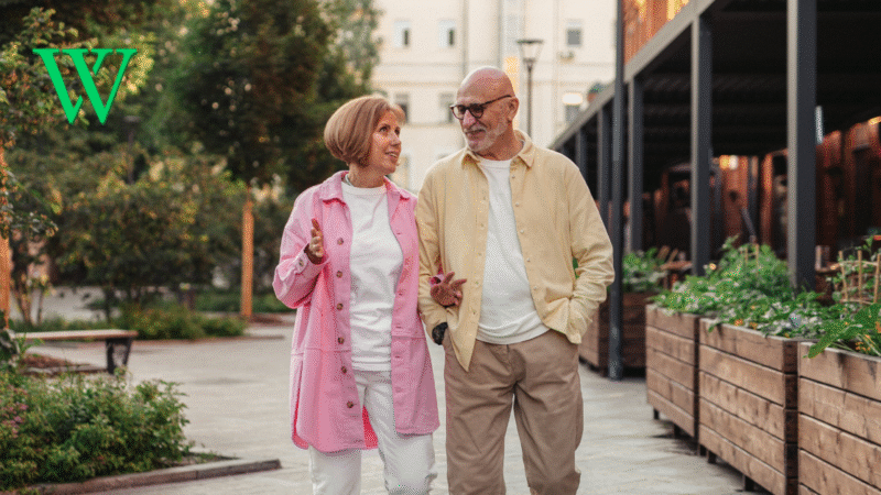 Senior couple walking along path